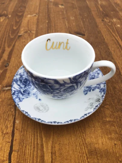 trendy coffee cups with funny sayings-Cunt | Vulgar vintage style blue floral tea cup and saucer set with metallic gold lettering